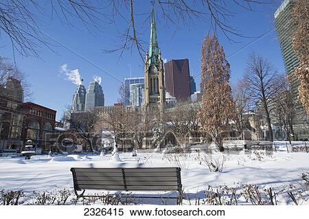 Stock Photography - St james park and st james cathedral with financial district in winter; Toronto ontario canada. Fotosearch