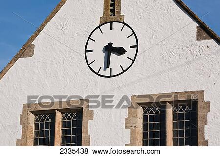 Stock Photo - St John's Church Clock; West Bay, Jurassic Coast, Dorset, England. Fotosearch