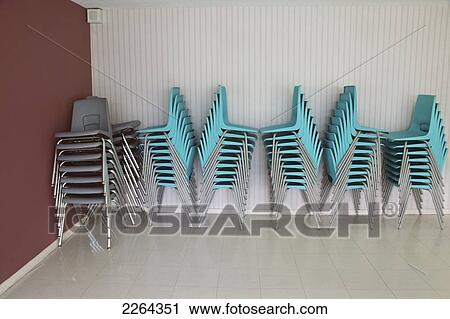 Stacked chairs in apartment building party room; toronto ontario canada View Large Photo Image Stock Image - Stacked chairs in apartment building party room; toronto ontario canada. Fotosearch