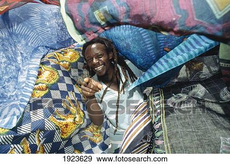 Stall Selling Cloth And Figurines View Large Photo Image Stock Photo - Stall Selling Cloth And Figurines. Fotosearch