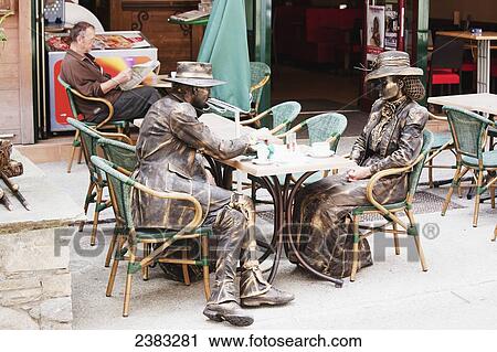 Stand-still artists dressed as old fashioned mountain climbers having a coffee break in centre of Chamonix-Mont Blanc; Chamonix, Mont Blanc Valley, France View Large Photo Image Stock Image - Stand-still artists dressed as old fashioned mountain climbers having a coffee break in centre of Chamonix-Mont Blanc; Chamonix, Mont Blanc Valley, France. Fotosearch