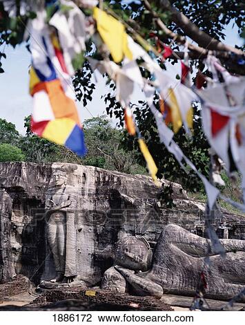 Standing And Reclining Buddha With Prayer Flags. View Large Photo Image Stock Image - Standing And Reclining Buddha With Prayer Flags.. Fotosearch
