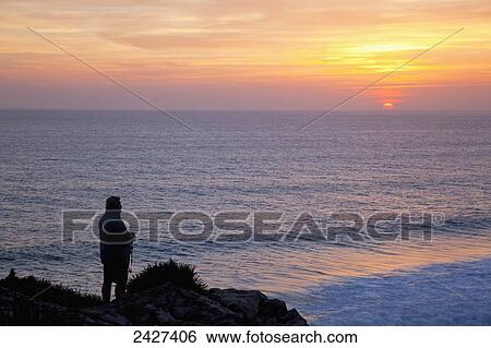 Standing at the water's edge watching the sunset, near Zahora; Andalucia, Spain View Large Photo Image Stock Photograph - Standing at the water's edge watching the sunset, near Zahora; Andalucia, Spain. Fotosearch