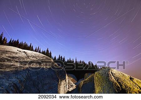Star Trails Over Rocks In Saguenay-St. Lawrence Marine Park; Ile-Aux-Lievres Quebec Canada View Large Photo Image Picture - Star Trails Over Rocks In Saguenay-St. Lawrence Marine Park; Ile-Aux-Lievres Quebec Canada. Fotosearch