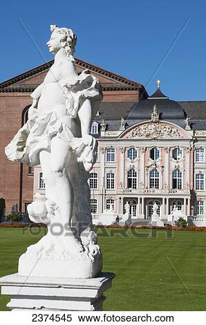 Stock Photography - Statue and building with ornate facade against a blue sky; Trier, Germany. Fotosearch