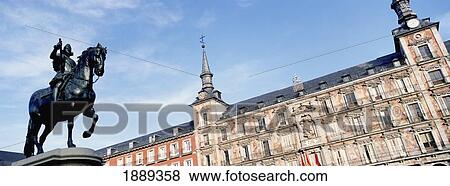 Stock Photo - Statue And Buildings In Plaza Major. Fotosearch