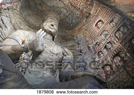 Stock Photo - Statue And Carvings In Ancient Buddhist Temple Grotto.. Fotosearch