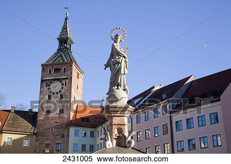 Statue, clock tower and buildings against a blue sky; Landsberg, Bavaria, Germany View Large Photo Image Stock Photography - Statue, clock tower and buildings against a blue sky; Landsberg, Bavaria, Germany. Fotosearch