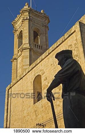 Stock Image - Statue In Front Of Gharb Parish Church. Fotosearch