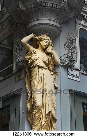 Stock Photograph - Statue of a woman on the corner of a building; Vienna, Austria. Fotosearch