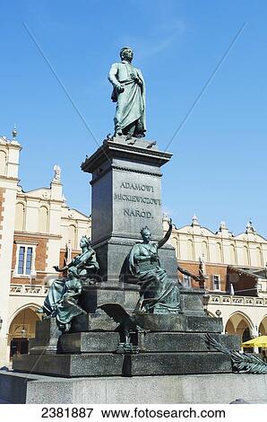 Stock Photo - Statue of Adam Mickiewicz in Rynek Glowny in front of old cloth guild; Krakow, Poland. Fotosearch