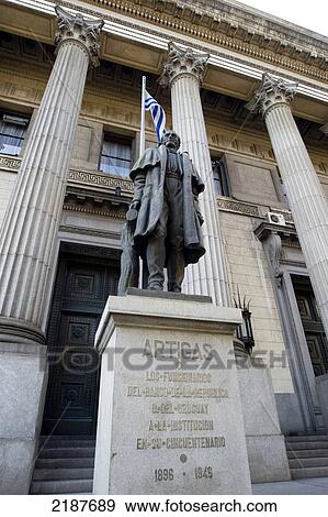 Stock Photo - Statue of General Jose Artigas in front of the Headquarters of Republica Oriental del Uruguay Bank, historical site built in 1926-38, Italian Neoclacissism style, Montevideo, Uruguay, South America. Fotosearch