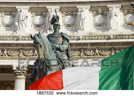 Stock Image - Statue Of King Emanuele Ii And Italian Flag In Front Of The Vittorio Emanuele Monument. Fotosearch