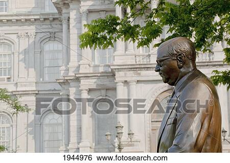 Stock Photograph - Statue Of Mayor Jean Drapeau With Montreal City Hall In The Background; Montreal Quebec Canada. Fotosearch