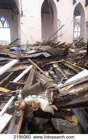 Stock Image - Statue Of Monk With Child In The Ruins Of The Catholic Cathedral After Being Hit By Hurricane Ivan, St Georges, Grenada.. Fotosearch