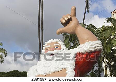 Statue of Santa Claus giving the shaka sign; Honolulu, Oahu, Hawaii, United States of America View Large Photo Image Stock Photo - Statue of Santa Claus giving the shaka sign; Honolulu, Oahu, Hawaii, United States of America. Fotosearch