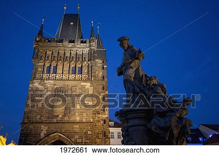 Stock Image - Statue Of St. Ivo On The Charles Bridge And Stare Mesto Tower At Night, Prague, Czech Republic. Fotosearch