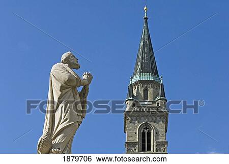 Stock Photograph - Statue Of St Peter And Collegiate Church, Close Up. Fotosearch
