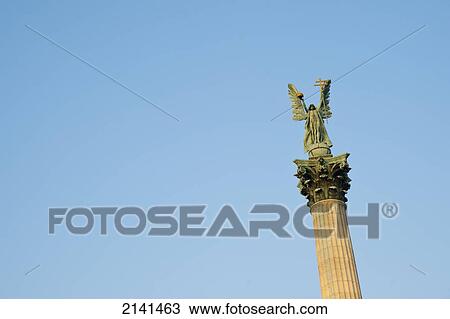 Stock Image - Statue Of The Archangel Gabriel, That Holds The Holy Crown Of St. Stephen, Heroes Square, Budapest, Hungary. Fotosearch
