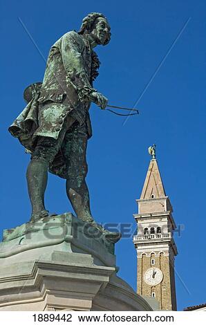 Stock Image - Statue Of The Local Composer And Violinist Giuseppe Tartini (1692-1770) And The Clock Tower Of St. George's Cathedral.. Fotosearch
