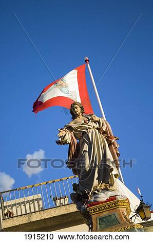 Stock Image - Statue With Flag. Fotosearch