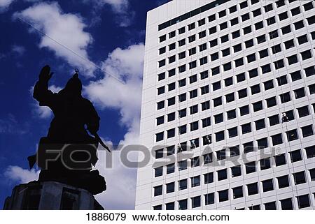 Stock Photo - Statues Highlighting Korean Victory In Past Wars Beside Modern Highrise. Fotosearch