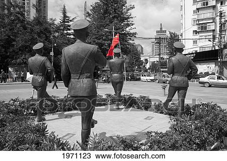 Stock Image - Statues Of Chinese Soldiers Holding A Flag Of China; Kunming Yunnan China. Fotosearch