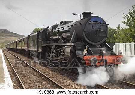 Steam Coming From A Train Moving Down The Tracks; Mallaig Highlands Scotland View Large Photo Image Stock Photo - Steam Coming From A Train Moving Down The Tracks; Mallaig Highlands Scotland. Fotosearch