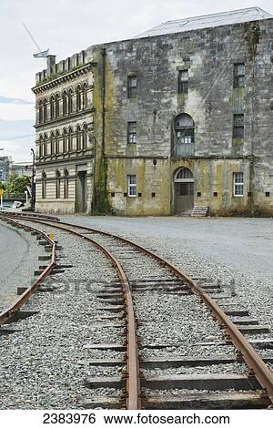 Stock Photograph - Steampunk HQ building and train tracks; Oamaru, South Island, New Zealand. Fotosearch