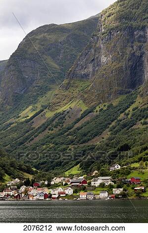 Stock Image - Steep Mountainside With Houses In The Valley Along The Water; Undredal Sognefjord Norway. Fotosearch