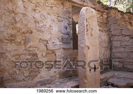 Stock Photograph - Stele 35, On Which Carvings On Both Its Faces Show Lady Skull-Ik With The Vision Of The Snake, In Front Of Structure 21, Yaxchilan, Chiapas, Mexico. Fotosearch