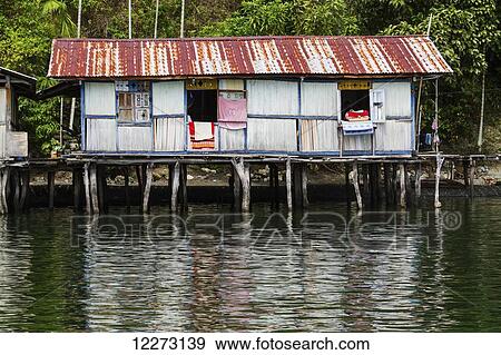 Stock Photo - Stilt house in Kampung Ayapo, Lake Sentani, Papua, Indonesia. Fotosearch