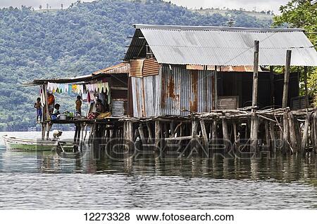 Stock Photo - Stilt house in Kampung Ayapo, Lake Sentani, Papua, Indonesia. Fotosearch