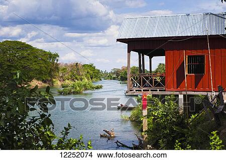 Picture - Stilt house on the island of Don Det on the Mekong River along the Cambodia/Laos border; Si Phan Don, Laos. Fotosearch