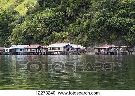Stock Image - Stilt houses in Kampung Ayapo, Lake Sentani, Papua, Indonesia. Fotosearch