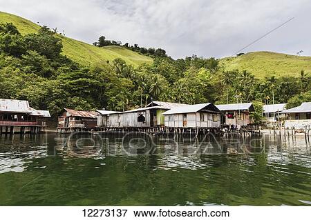 Stock Photo - Stilt houses in Kampung Ayapo, Lake Sentani, Papua, Indonesia. Fotosearch