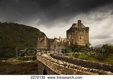 Stock Photography - Stone Bridge Leading To A Castle Under A Stormy Sky; Kyle Of Lochalsh Highlands Scotland. Fotosearch