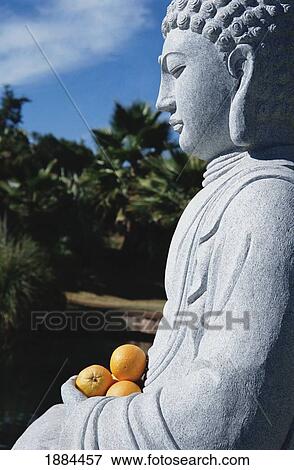 Stone Buddha Holding Oranges View Large Photo Image Stock Photo - Stone Buddha Holding Oranges. Fotosearch