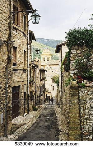 Stock Photo - Stone buildings and narrow street; Spello, Umbria, Italy. Fotosearch