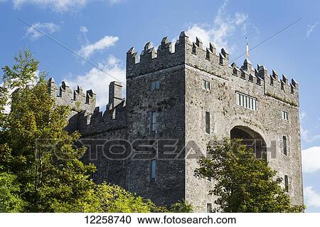 Stone castle with trees, blue sky and clouds; Bunratty, County Clare, Ireland View Large Photo Image Stock Image - Stone castle with trees, blue sky and clouds; Bunratty, County Clare, Ireland. Fotosearch