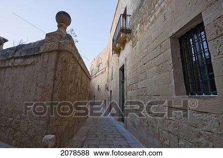 Stone Houses On A Narrow Street, Mdina, Malta View Large Photo Image Stock Photo - Stone Houses On A Narrow Street, Mdina, Malta. Fotosearch