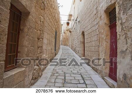 Stock Photograph - Stone Houses On A Narrow Street, Mdina, Malta. Fotosearch