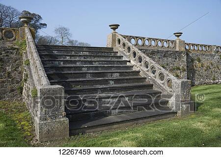 Stone stairway and balustrade leading to garden terrace in grounds of Clovelly Court Gardens; Clovelly, Devon, England View Large Photo Image Stock Photo - Stone stairway and balustrade leading to garden terrace in grounds of Clovelly Court Gardens; Clovelly, Devon, England. Fotosearch