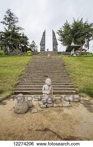 Stock Photograph - Stone statue and ceremonial gate of Candi Cetho, a Javanese-Hindu temple located on the western slope of Mount Lawu, Central Java, Indonesia. Fotosearch