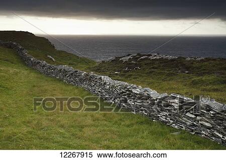 Stock Photography - Stone wall above the cliffs on Inishturk Island, Wild Atlantic Way; County Mayo, Ireland. Fotosearch