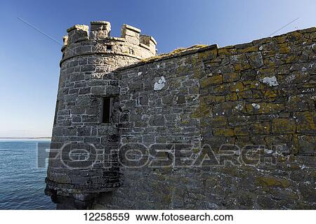 Stone wall with turret at water's edge and blue sky; Carrigaholt, County Clare, Ireland View Large Photo Image Stock Photo - Stone wall with turret at water's edge and blue sky; Carrigaholt, County Clare, Ireland. Fotosearch