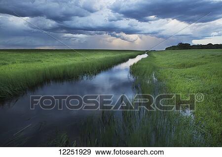 Stock Photo - Storm clouds at sunset, near Winnipeg; Manitoba, Canada. Fotosearch