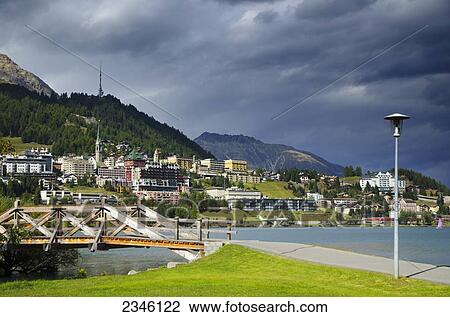 Stock Image - Storm Clouds Over A City In The Swiss Alps; St. Moritz, Grisons, Switzerland. Fotosearch