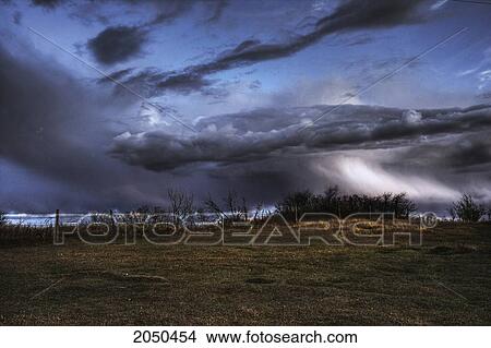 Picture - Storm Clouds Over A Cow Pasture In Autumn, Rural Alberta. Fotosearch