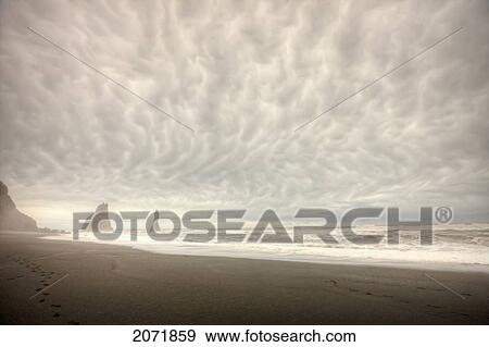 Storm Clouds Over The Ocean And Sea Stacks Near Vik, Southern Iceland View Large Photo Image Stock Photo - Storm Clouds Over The Ocean And Sea Stacks Near Vik, Southern Iceland. Fotosearch